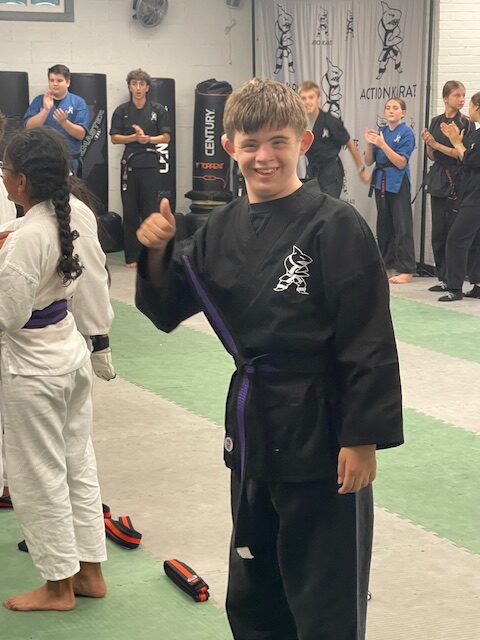 Kareem earning black belt with purple stripe